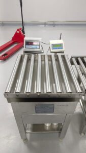 Stainless roller conveyor scale with dual indicators.